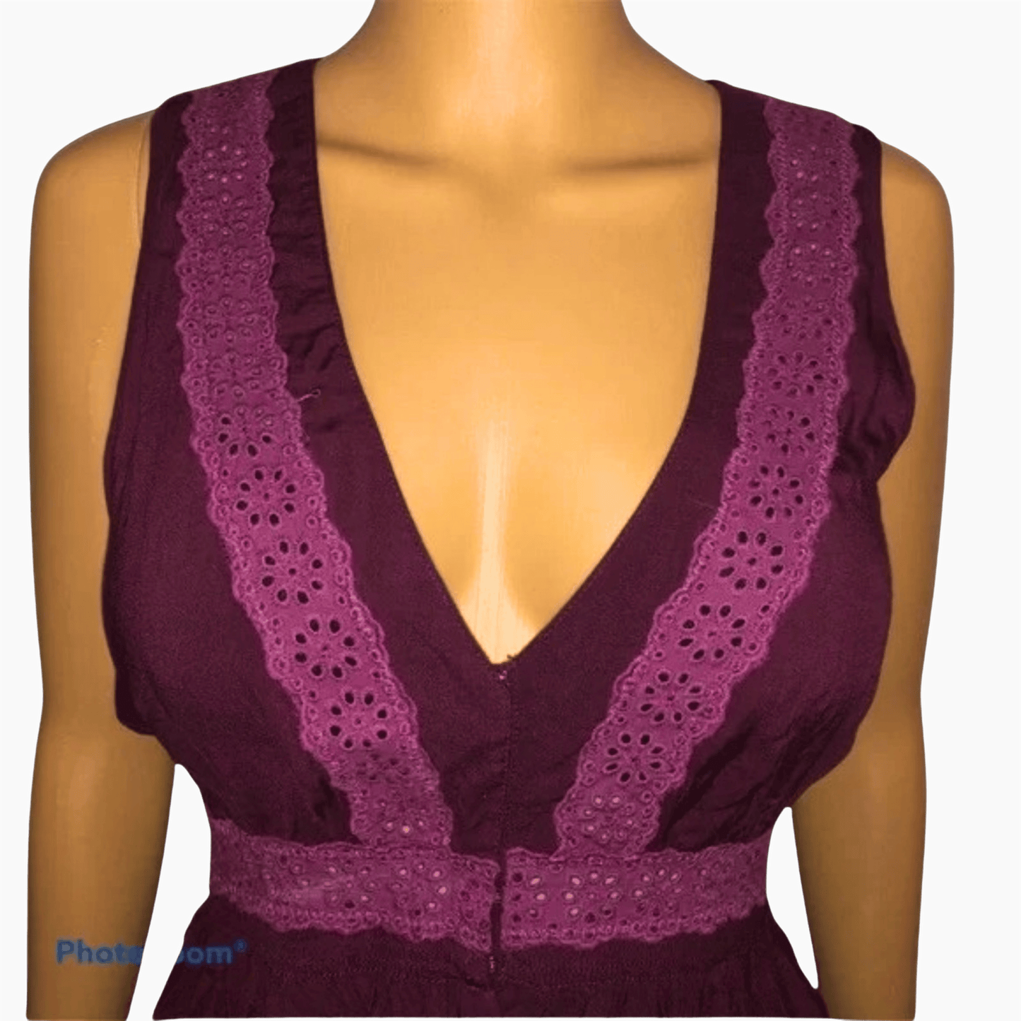 Purple lace-trimmed top on a mannequin against a gray background