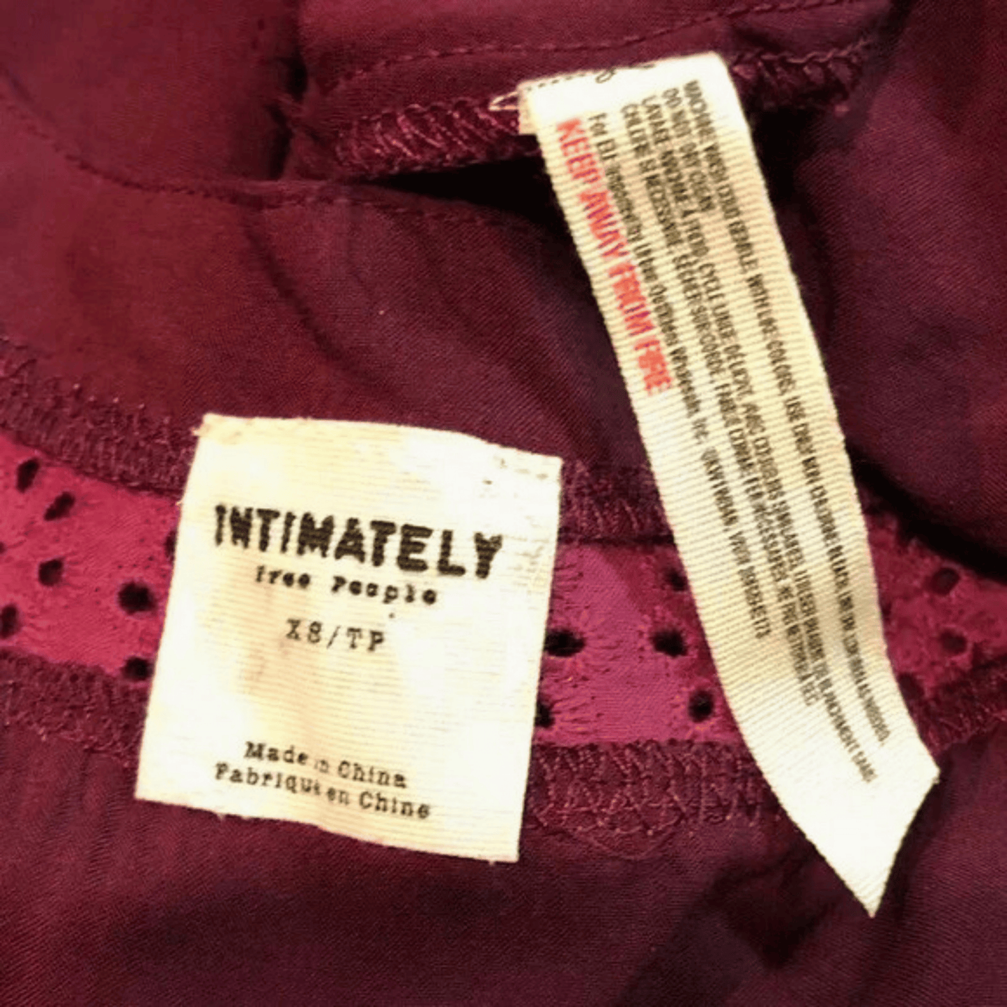 Close-up of a label on a garment with text and branding details.