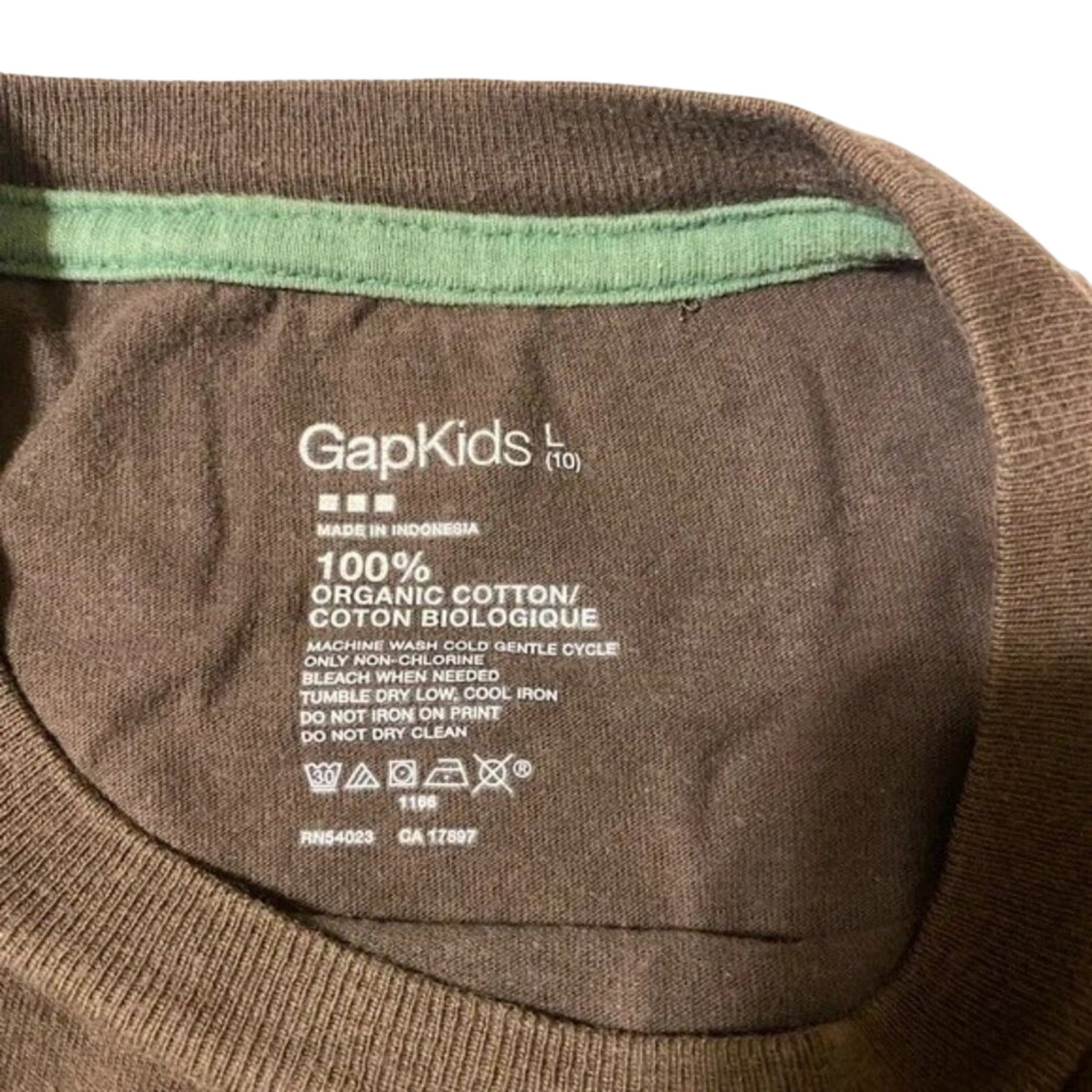 Close-up of a GapKids label on a brown garment with green lining.