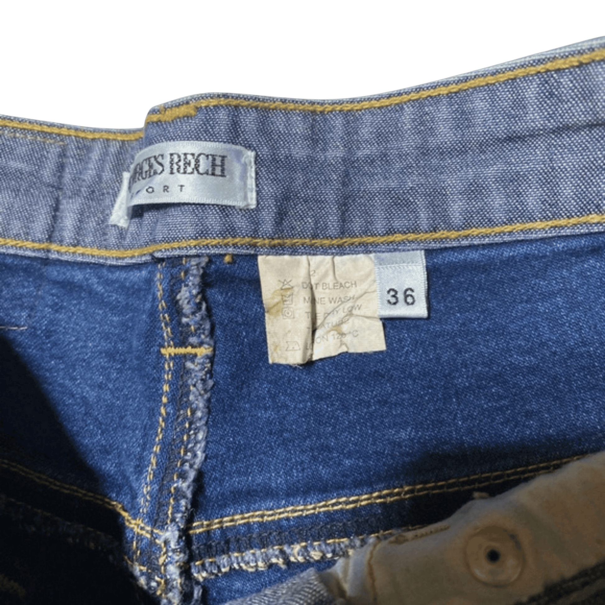 Close-up of a pair of blue jeans with a tag and size label.