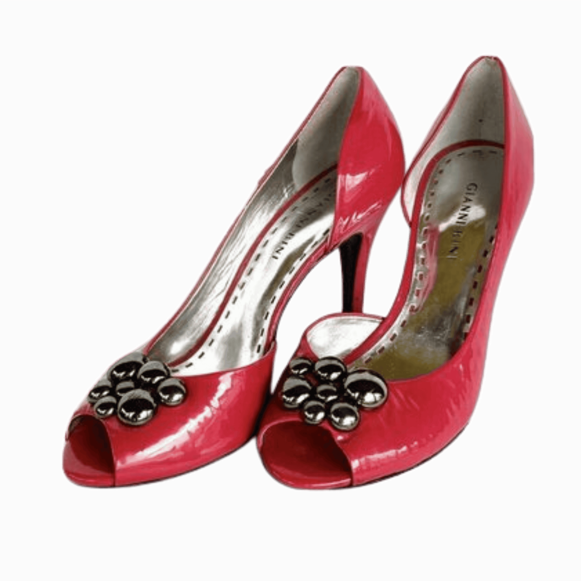 Red high-heeled shoes with decorative elements on a dark background