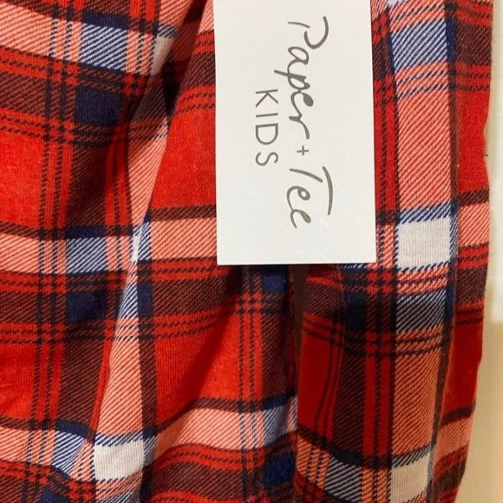 Red plaid fabric with a 'Paper + Tech Kids' tag.