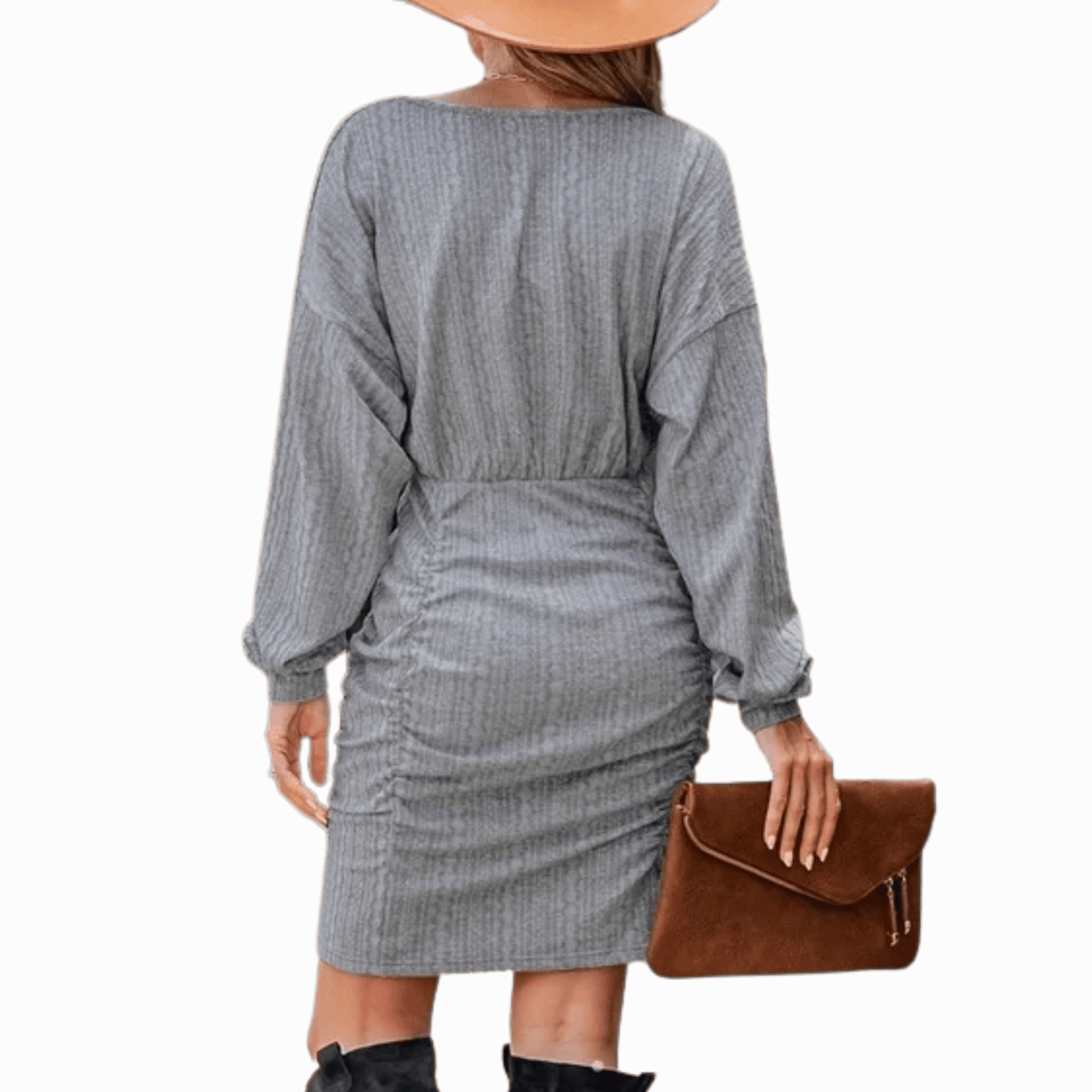 Person wearing a gray dress holding a brown clutch against a red background