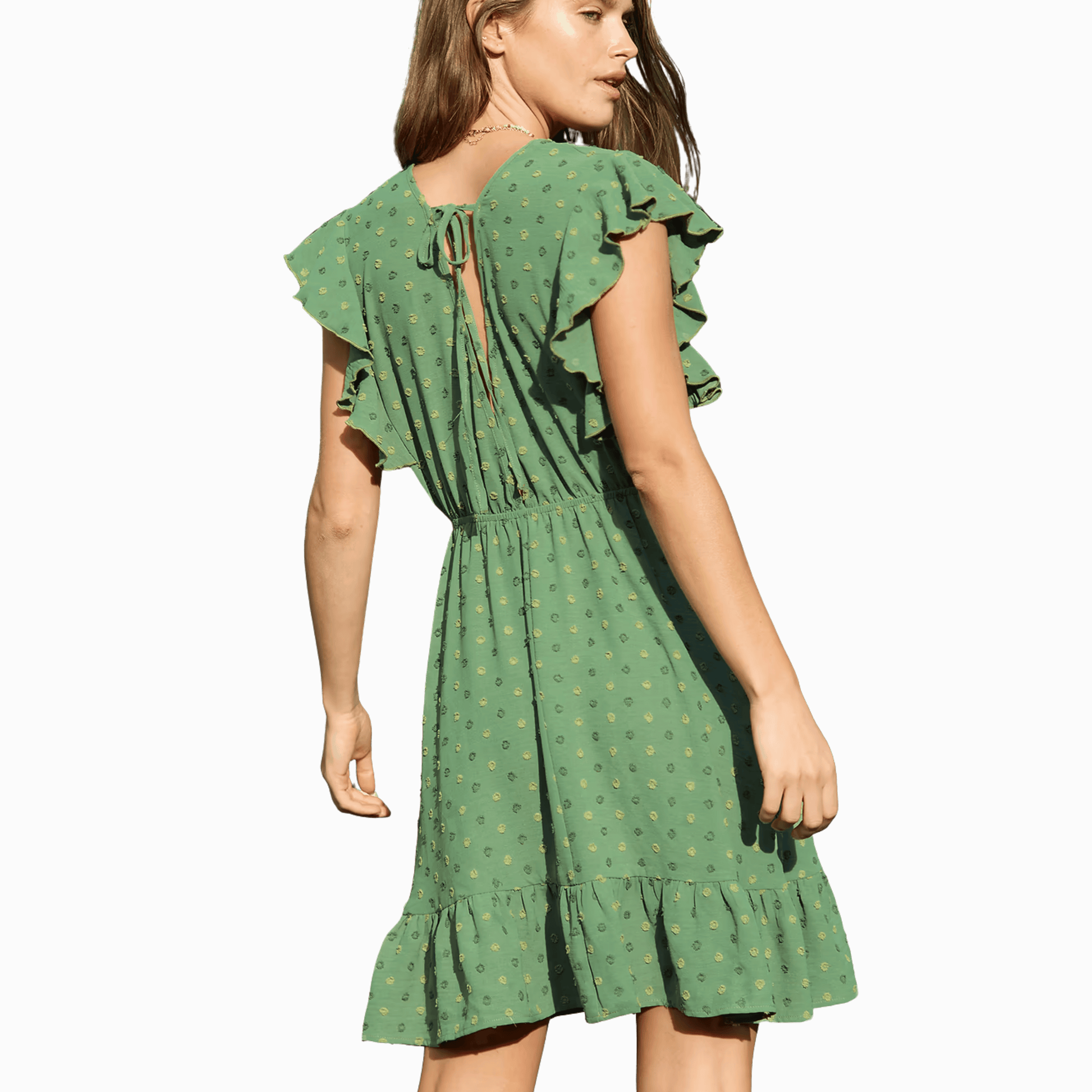 Green dress with ruffled sleeves and hem on a dark background