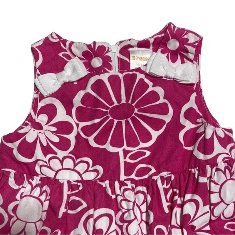 Pink dress with white floral pattern on a white background