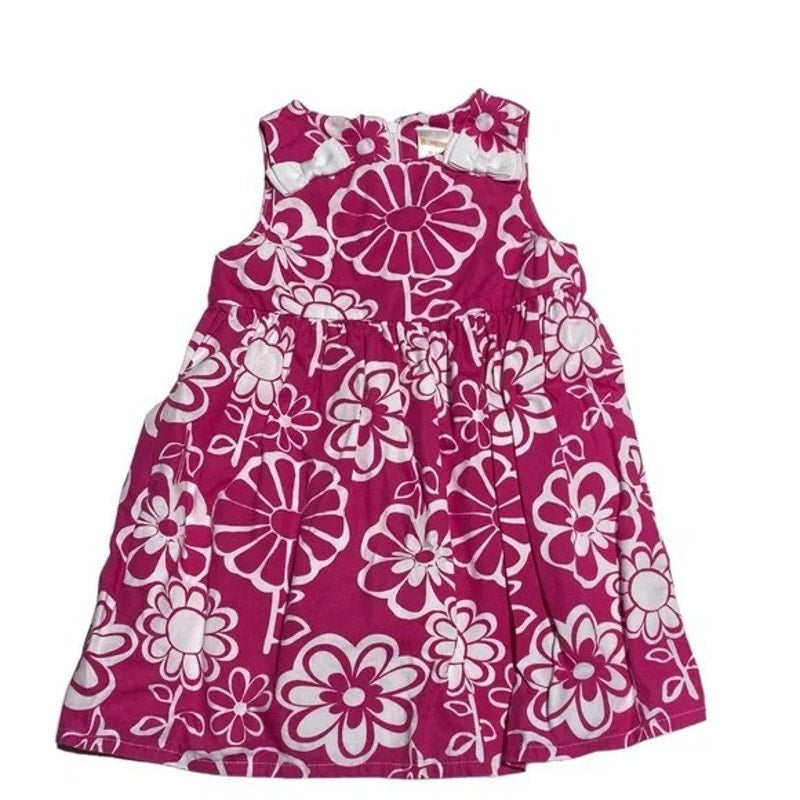 Pink dress with white floral pattern on a white background