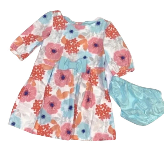 Floral dress with a blue bow and matching headband on a white background