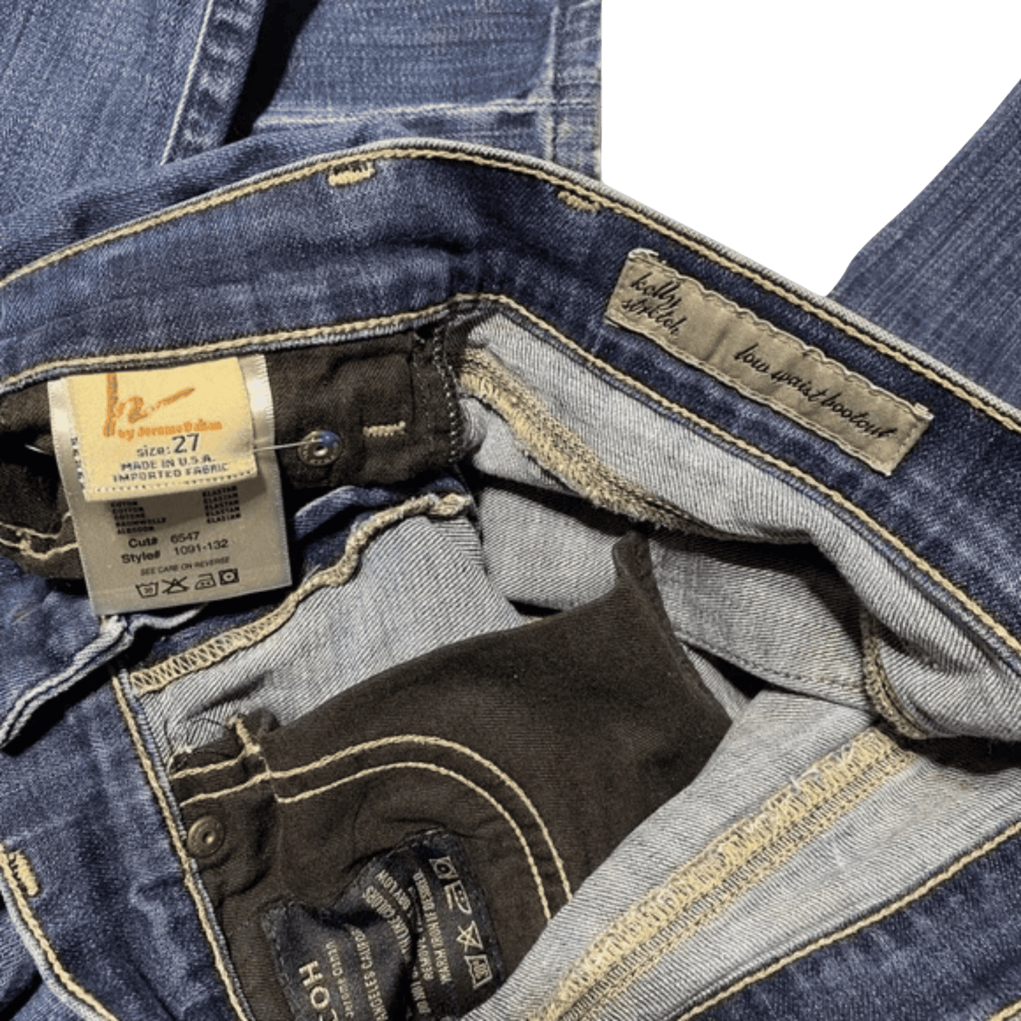 Close-up of blue jeans with a tag and brand label on a green background