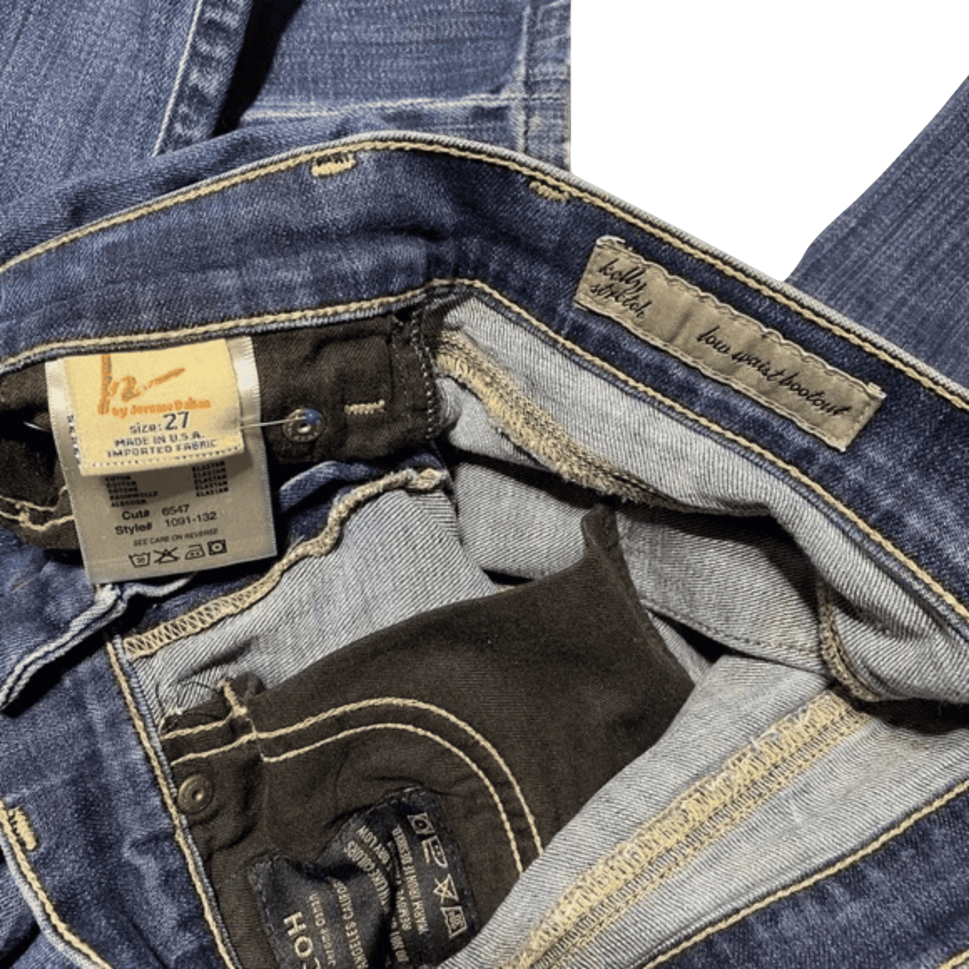 Close-up of blue jeans with a tag and brand label on a green background