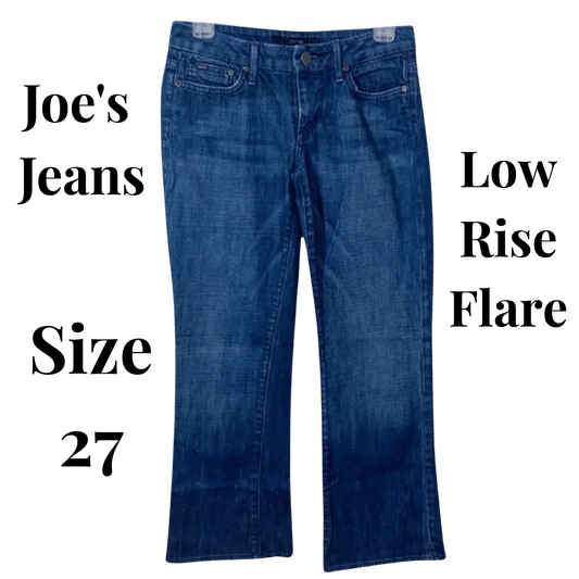 Blue jeans with text indicating brand, style, and size on a green background