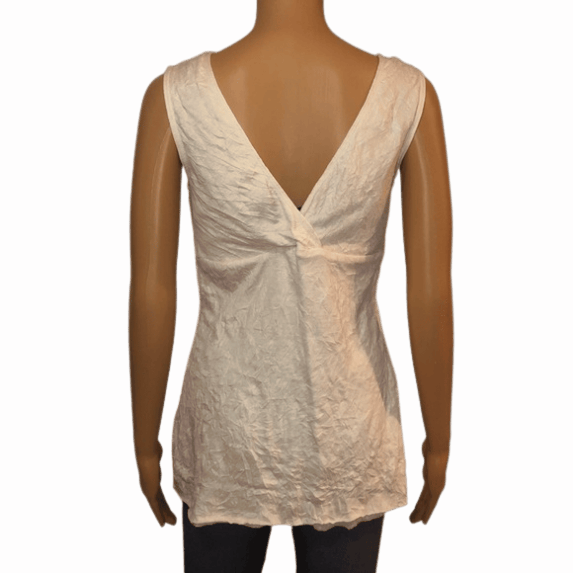 White lace top on a mannequin against a red background