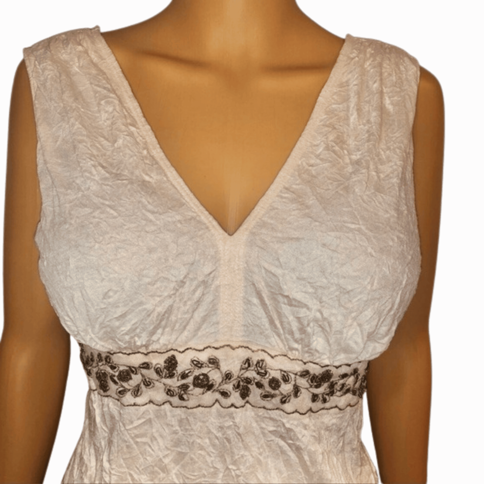 White lace dress with floral embroidery on a mannequin against a red background