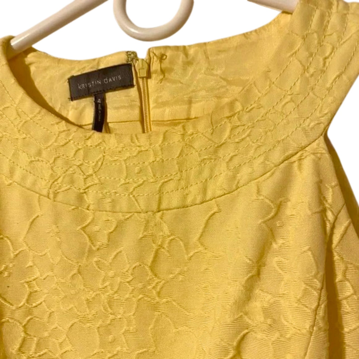 Yellow lace dress on a hanger with 'Klitten Davis' label.