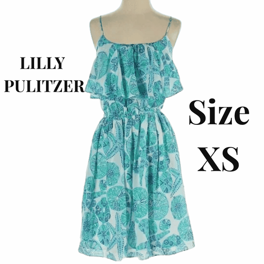 Teal patterned dress on a mannequin against a red background with 'LILLY PULITZER' and 'Size XS' text.