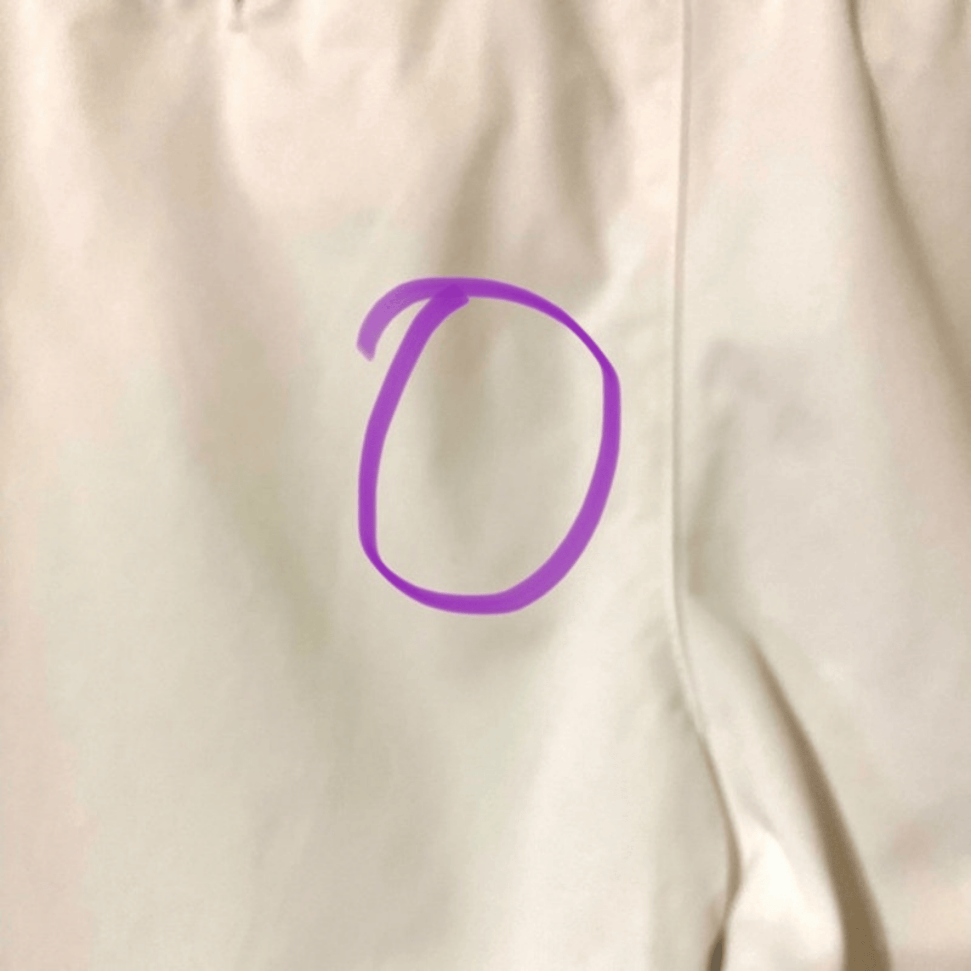 Purple circle on a beige fabric background