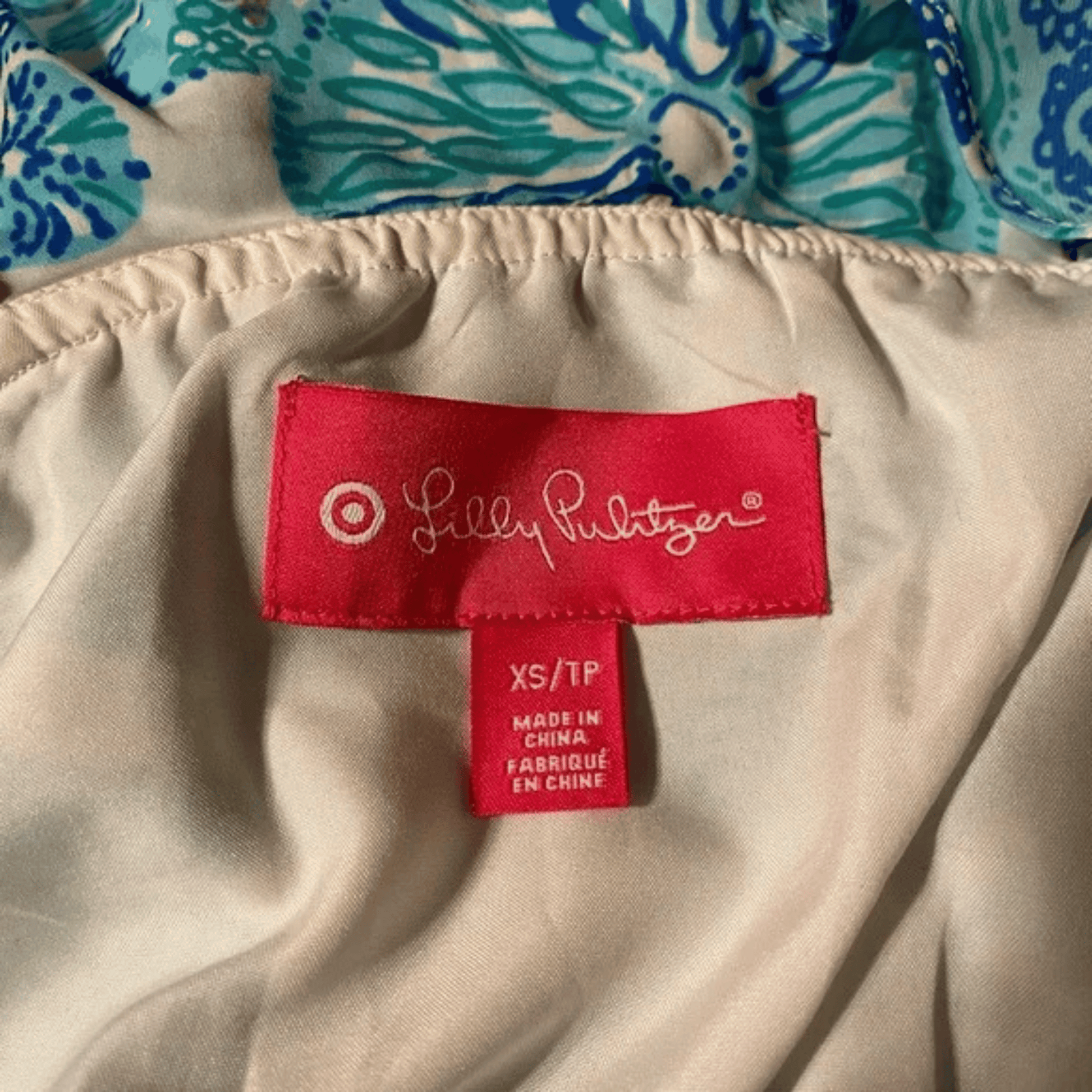Lilly Pulitzer label on a garment with floral pattern in the background
