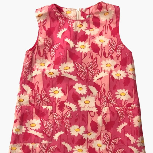 Pink sleeveless top with floral and butterfly pattern on a white background