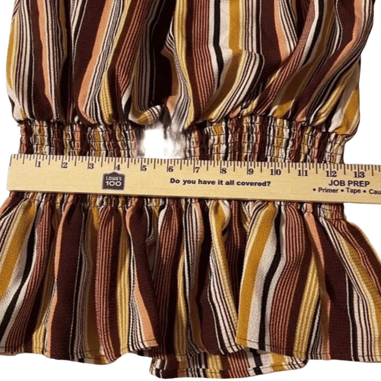 Striped fabric with a measuring tape indicating measurements