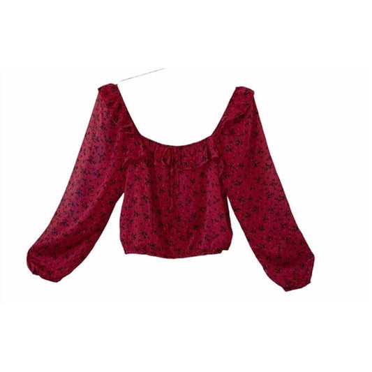 Red floral blouse with long sleeves on a white background
