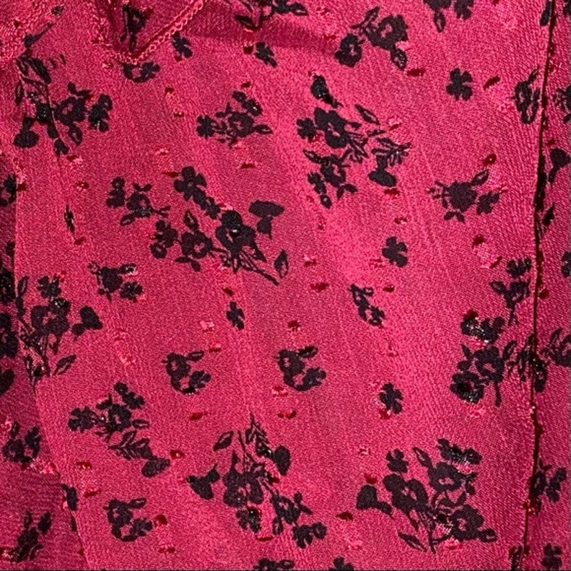 Close-up of a pink fabric with black floral pattern