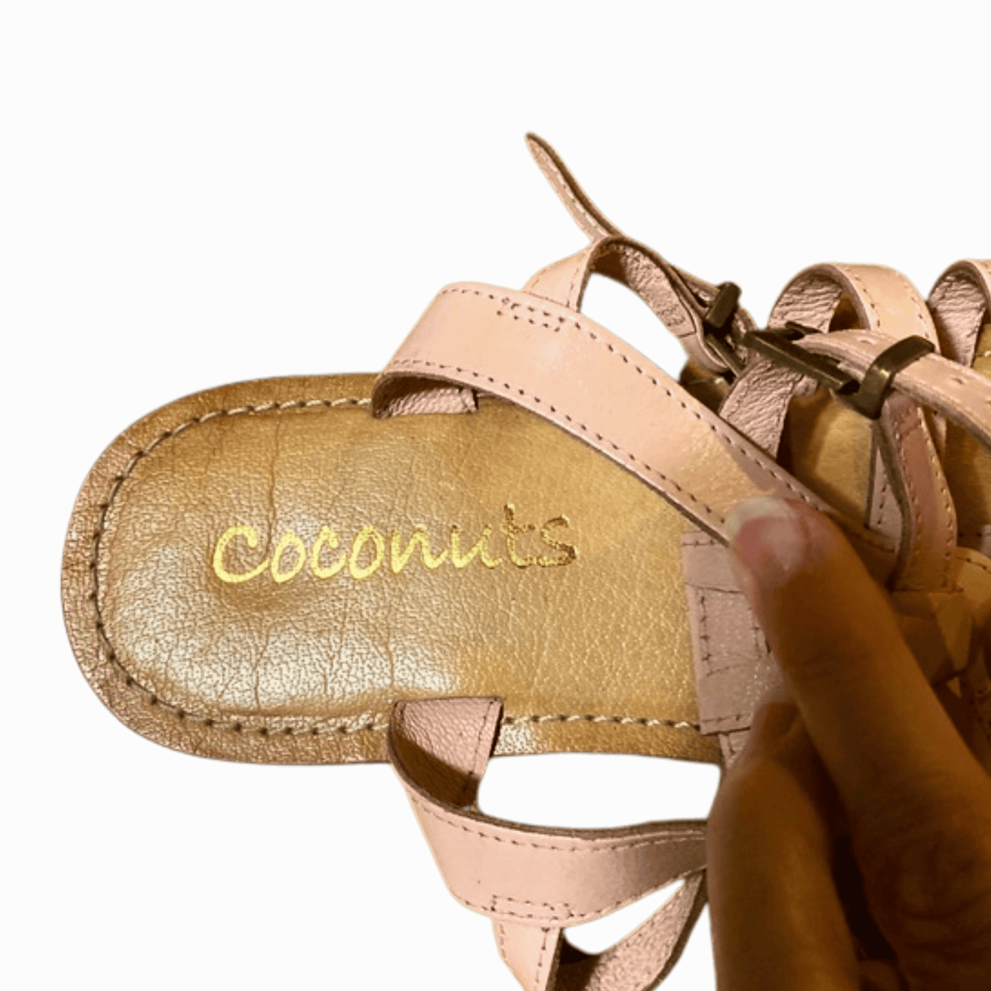 Close-up of a sandal with 'Coconuts' branding on a red background