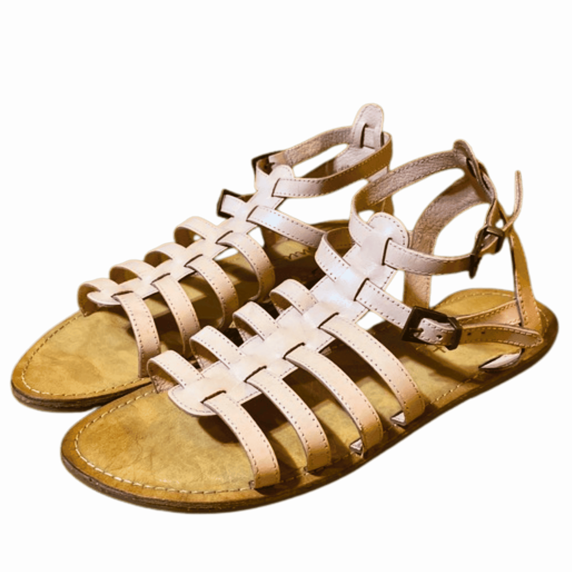 Pair of beige sandals with multiple straps on a black background