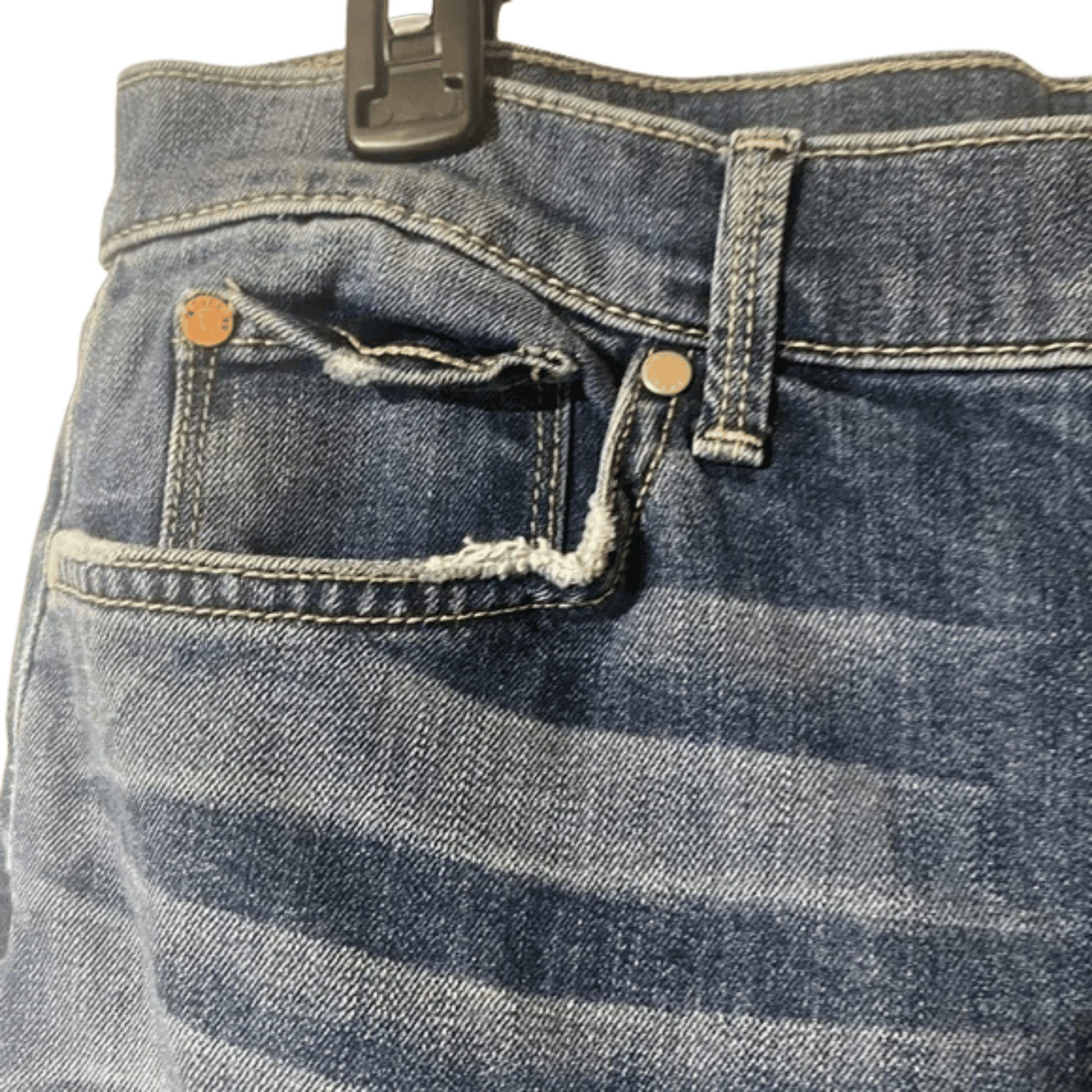 Close-up of a blue denim pocket with a button and zipper on a transparent background