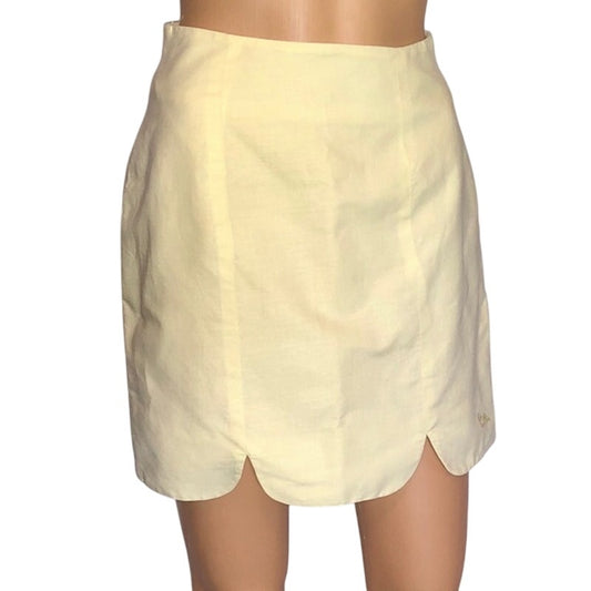 Light yellow skirt on a mannequin against a white background