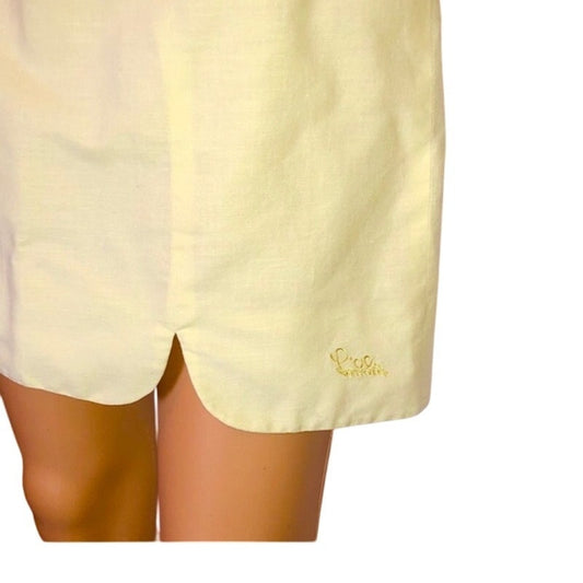 Light yellow shorts with a brand logo on a white background