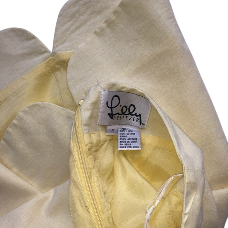 Close-up of a beige garment with a label on a white background