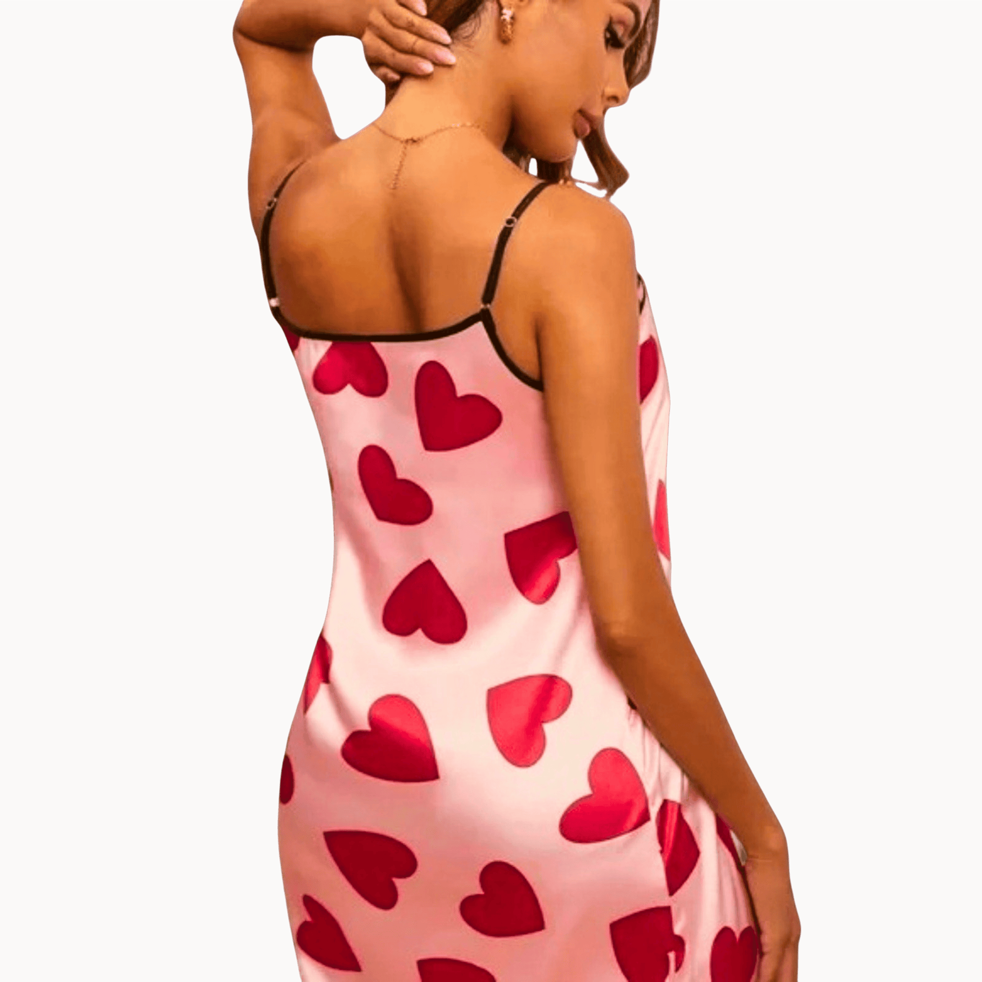 Woman wearing a pink dress with red heart patterns on a brown background