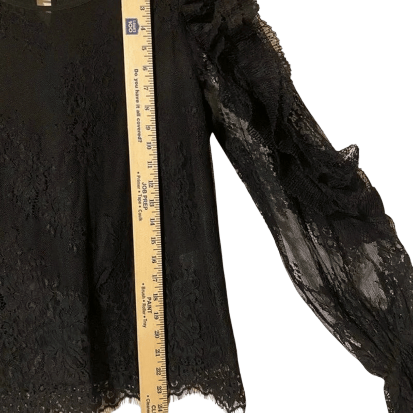 Black textured fabric with a wooden ruler for scale on a transparent background