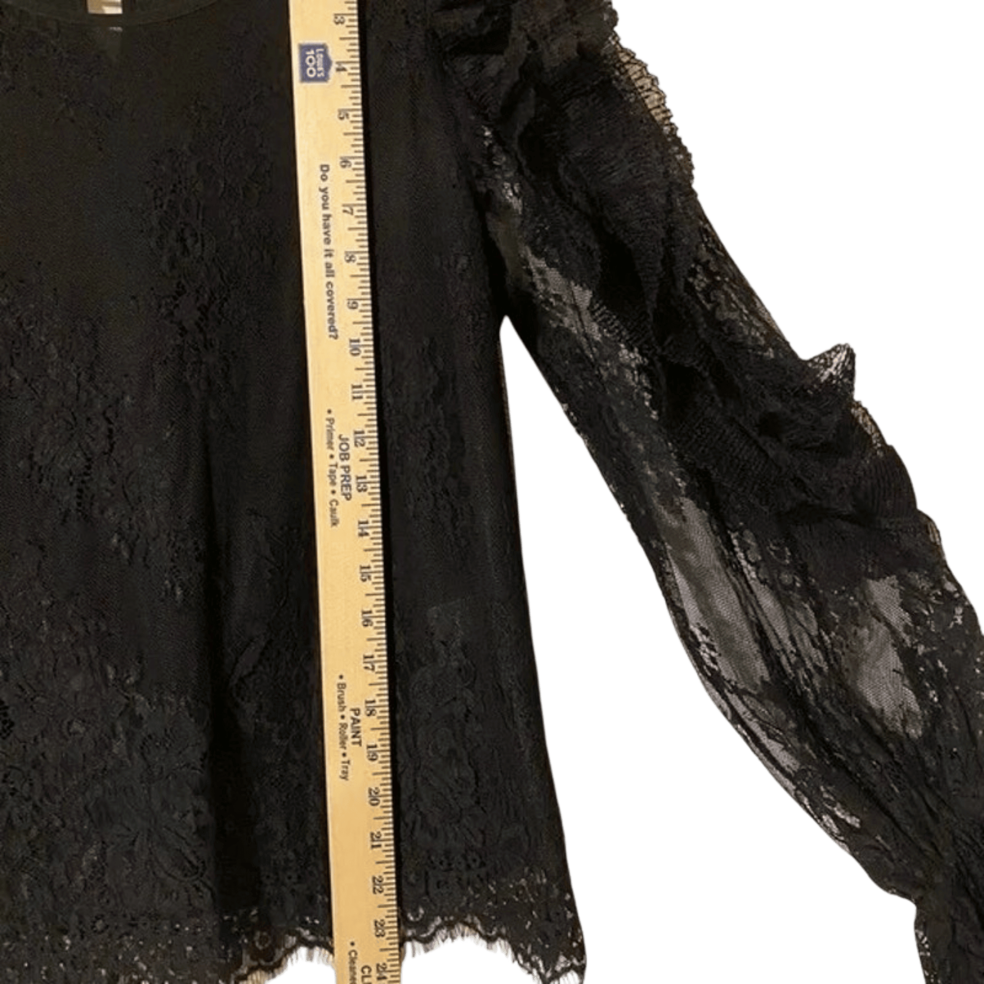 Black textured fabric with a wooden ruler for scale on a transparent background