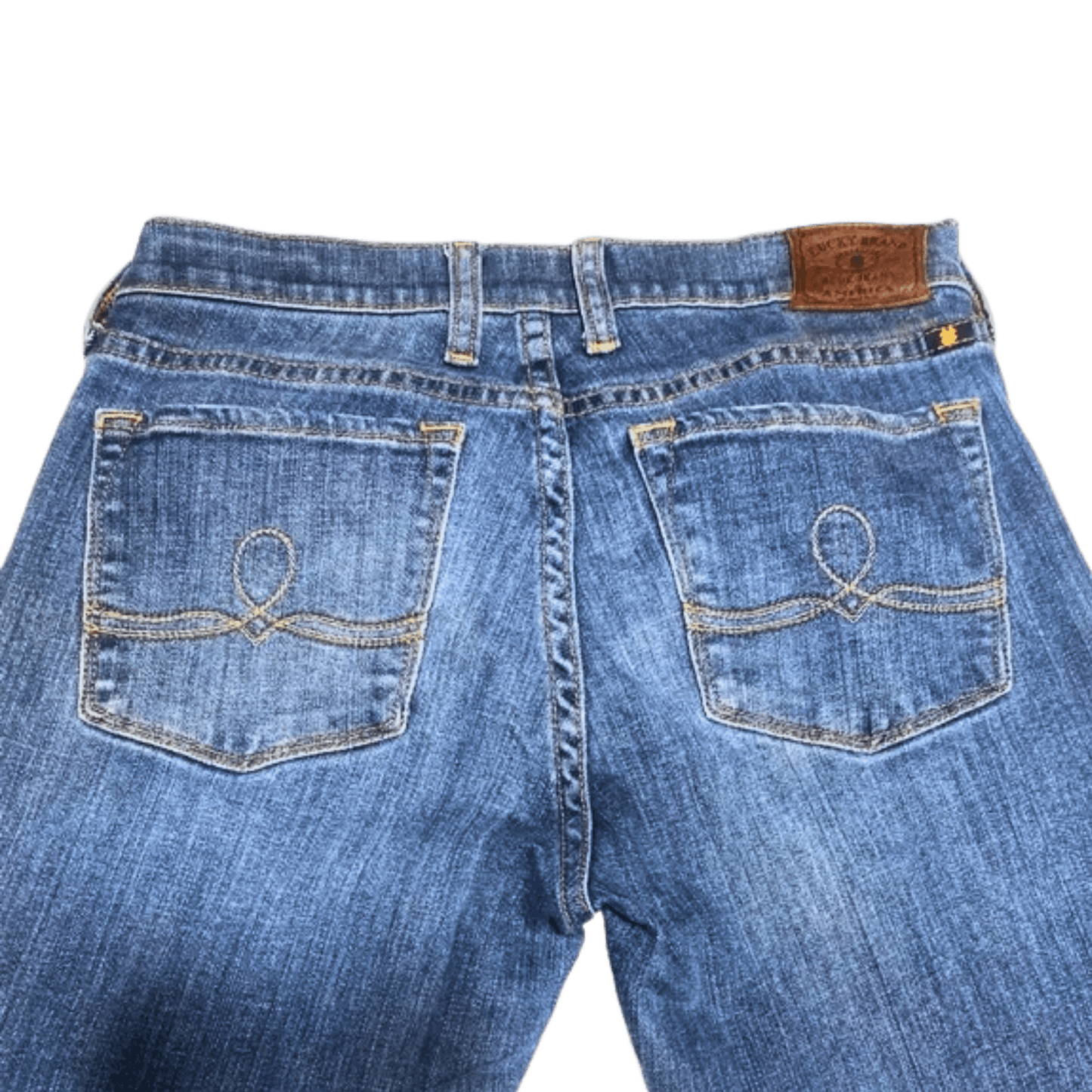 Back view of blue jeans with a brand label on a transparent background