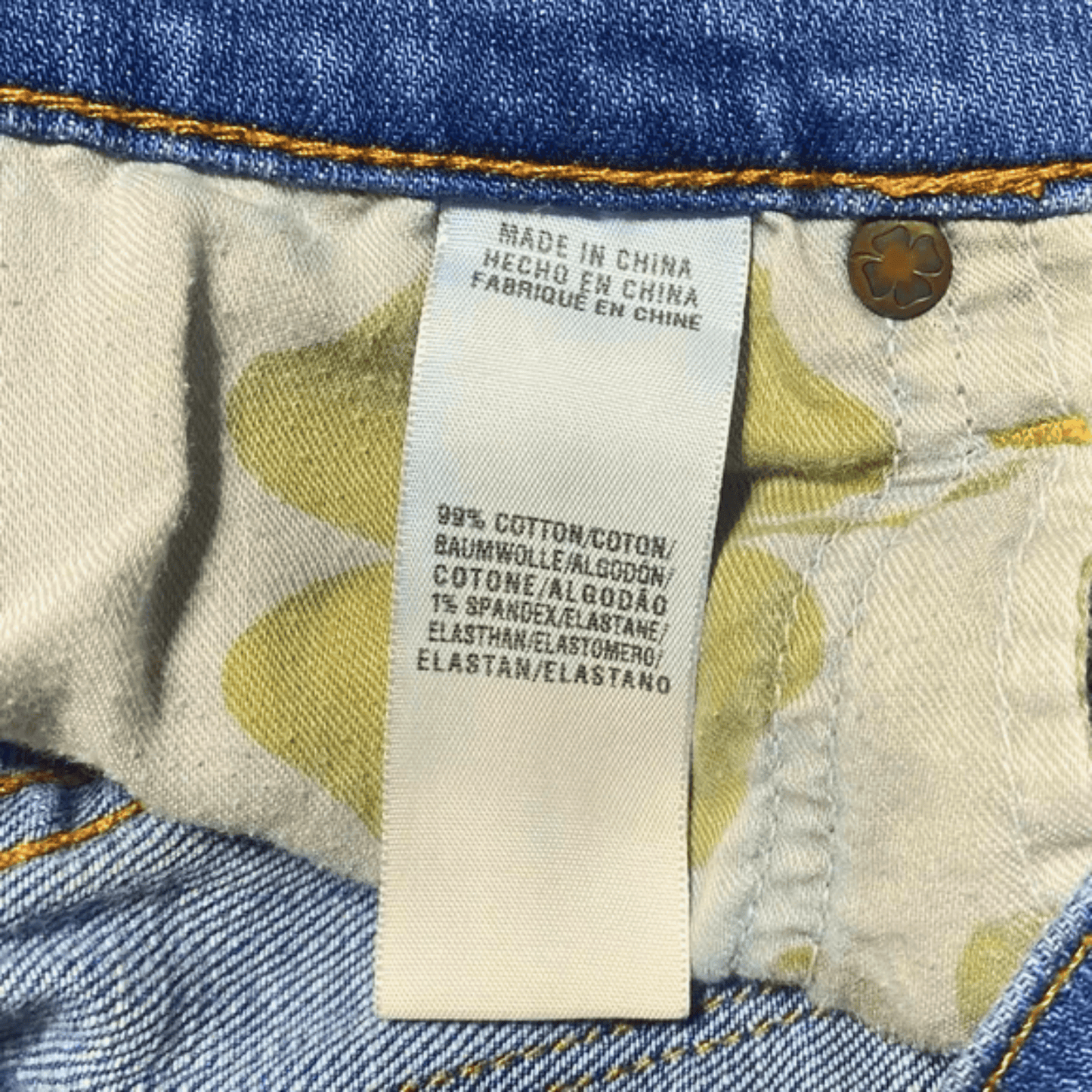 Close-up of a denim fabric with a label indicating 'Made in China' and material composition.