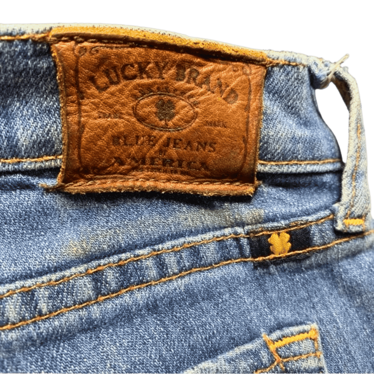 Close-up of a Lucky Brand label on a pair of blue jeans.