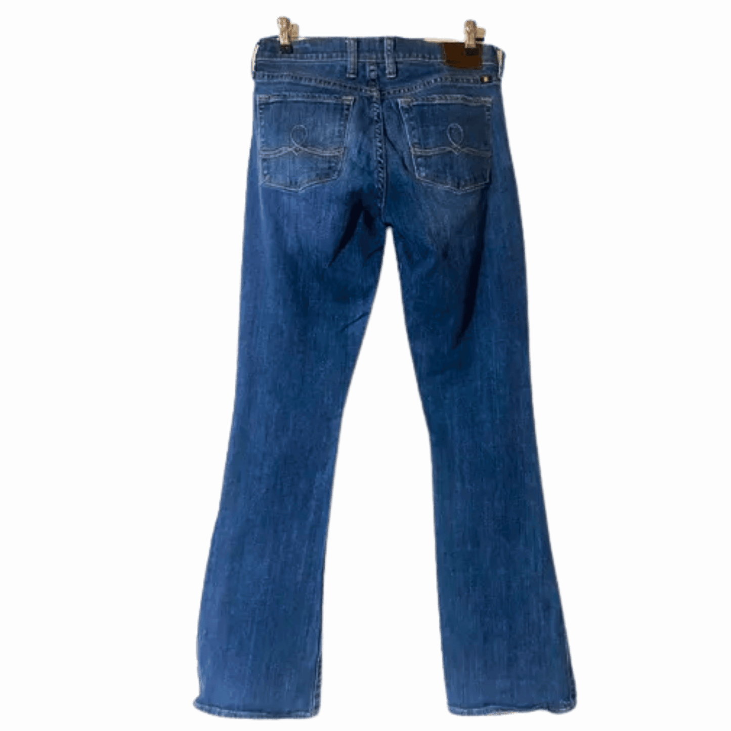 Blue jeans on a hanger against a blue background