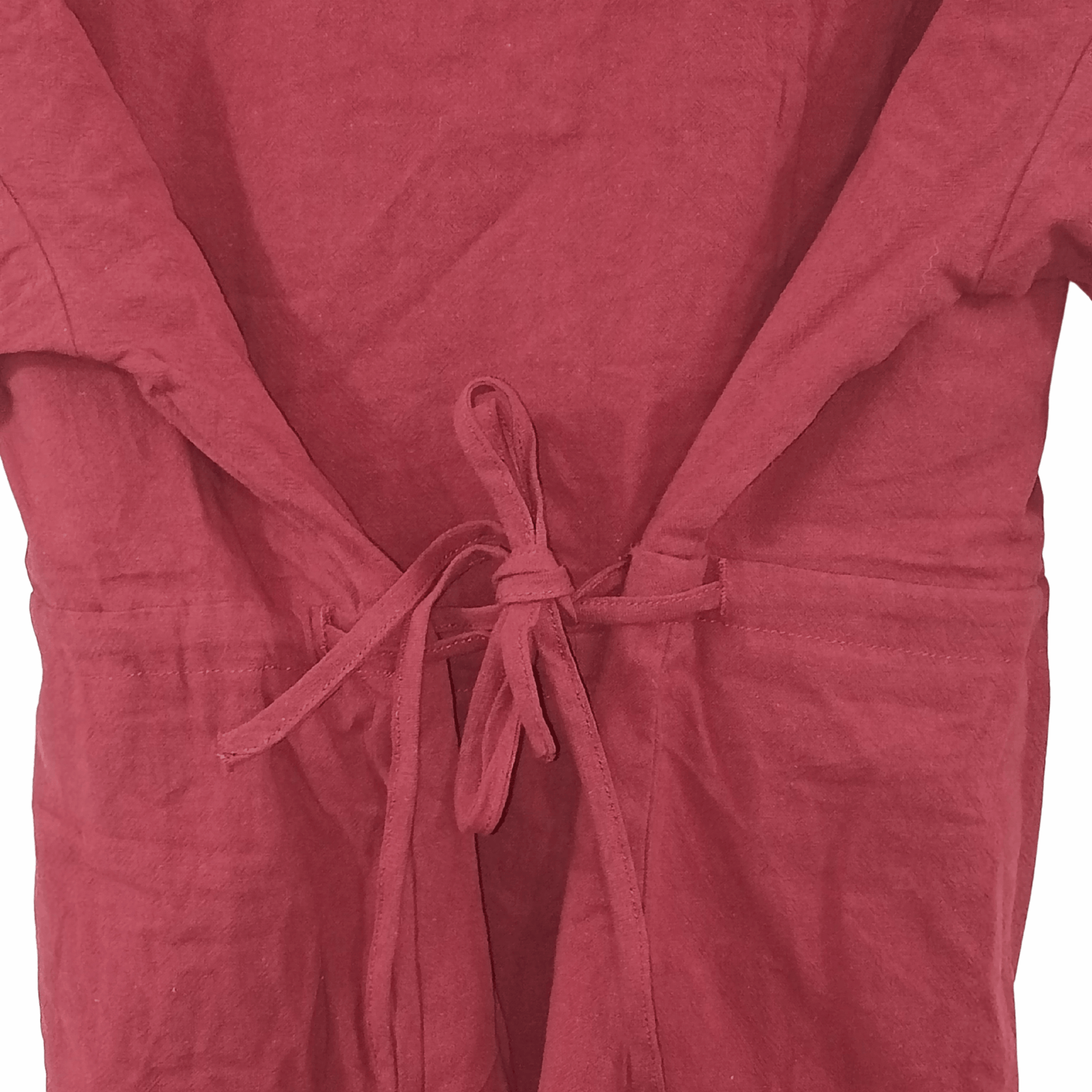 Close-up of a pink garment with a tie detail on a black background