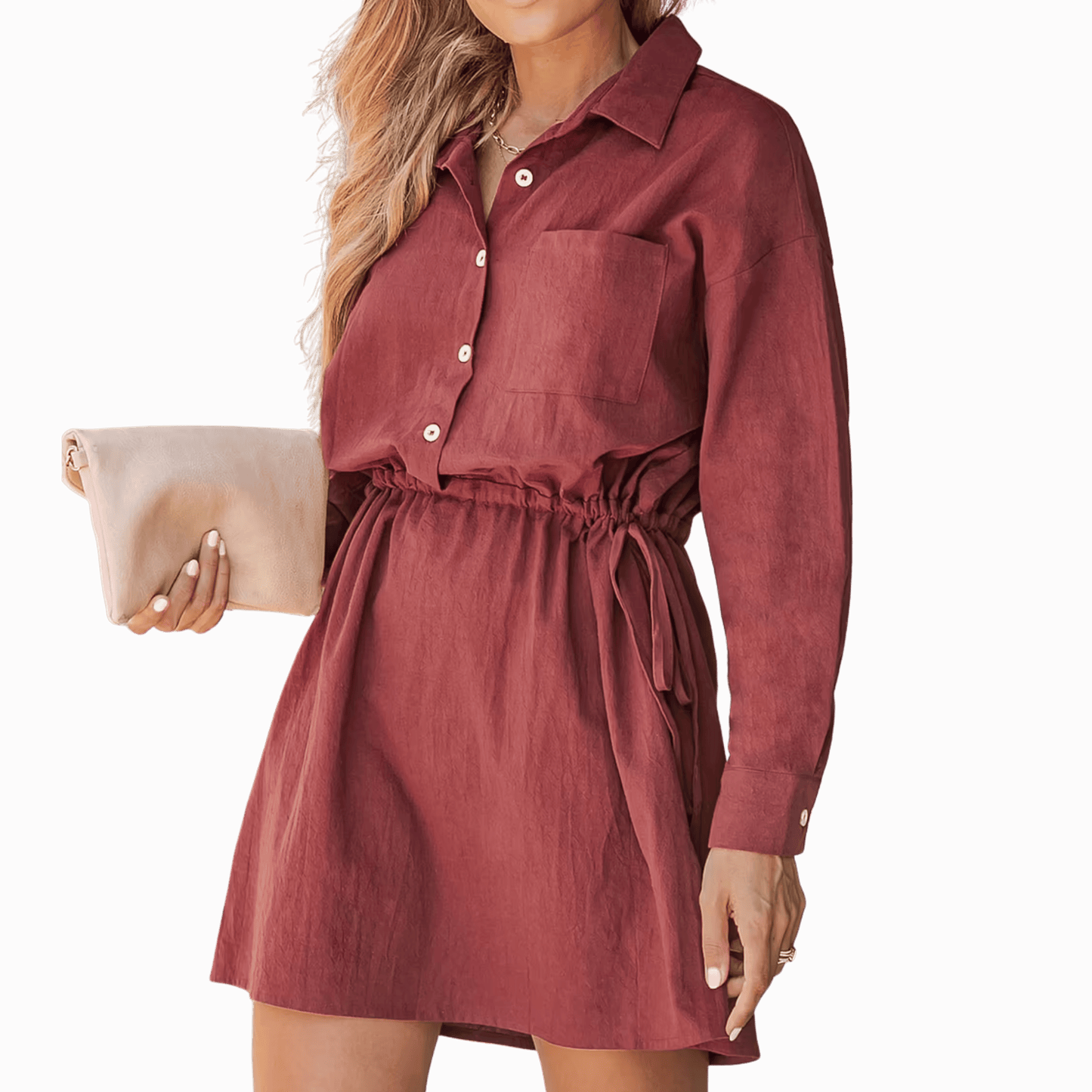 Woman wearing a burgundy dress holding a beige clutch against a brown background