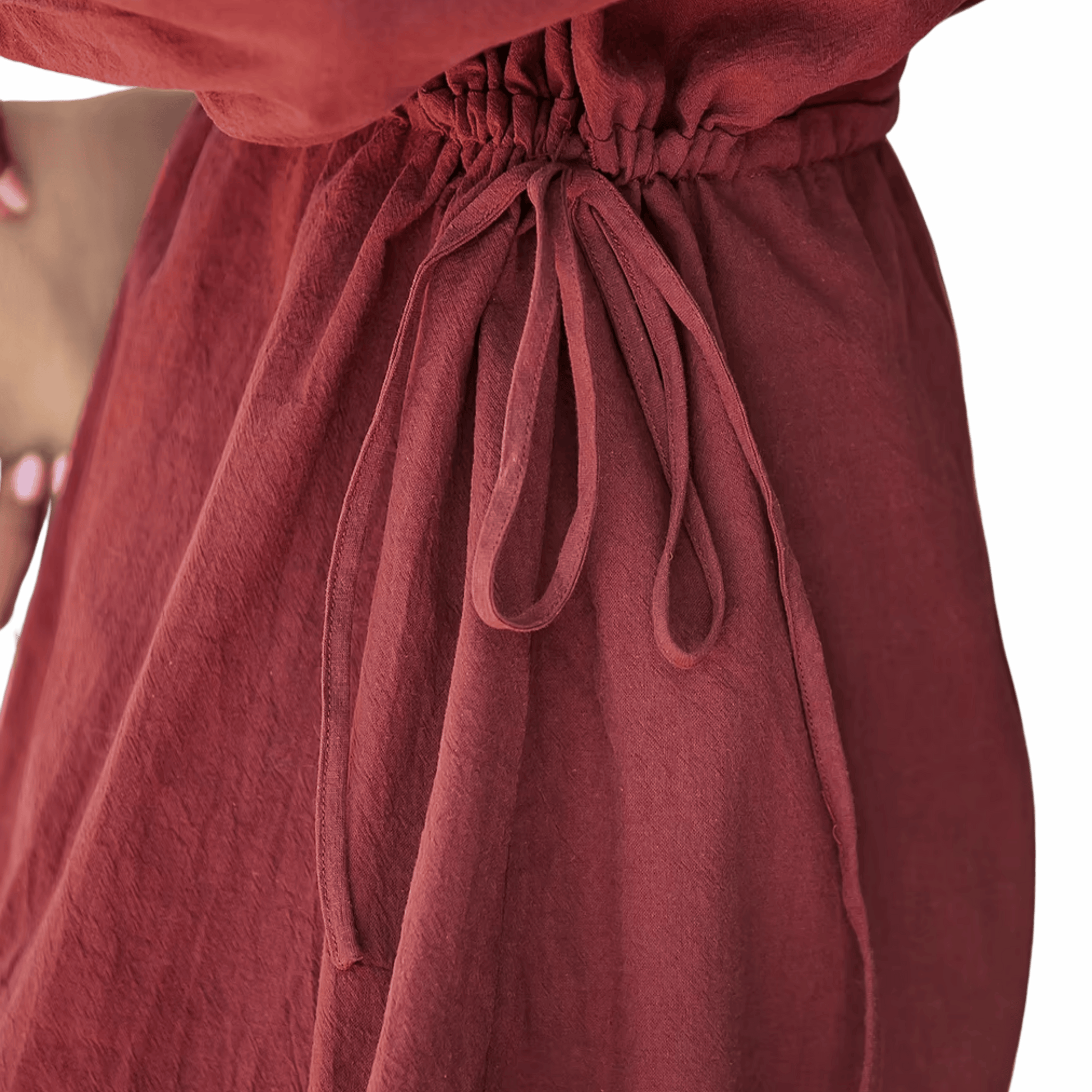 Close-up of a red dress with a tie waist on a black background