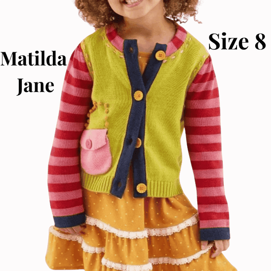 Child wearing a colorful outfit with 'Matilda Jane' branding on a red background