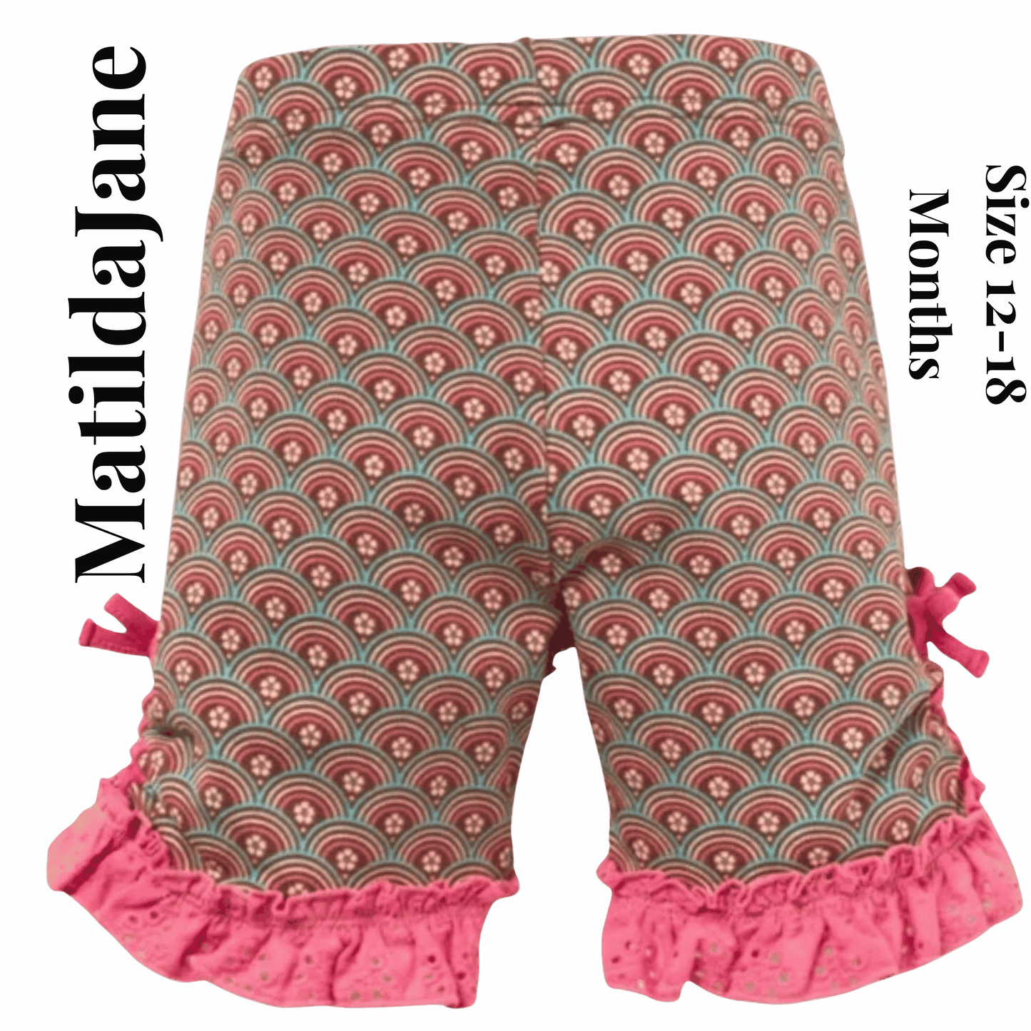Patterned baby pants with ruffles on a pink background, featuring the brand 'Matilda Jane'.