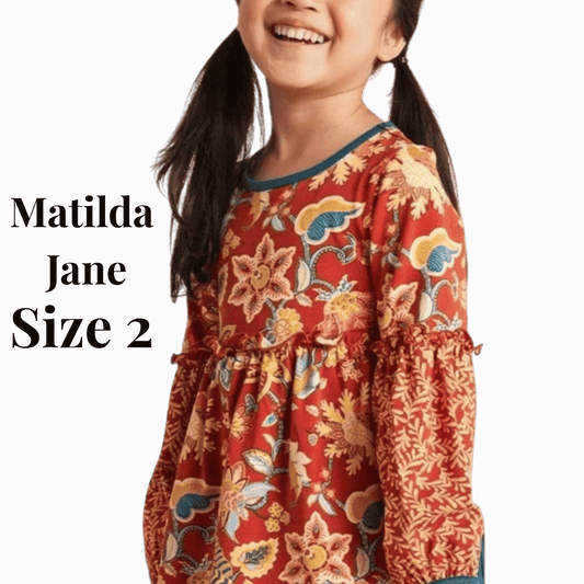 Child wearing a red floral dress with 'Matilda Jane' branding on a red background