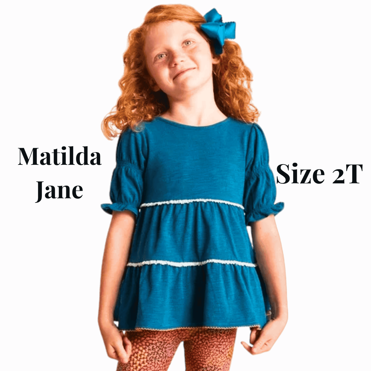 Young girl wearing a blue dress with 'Matilda Jane' branding on a purple background