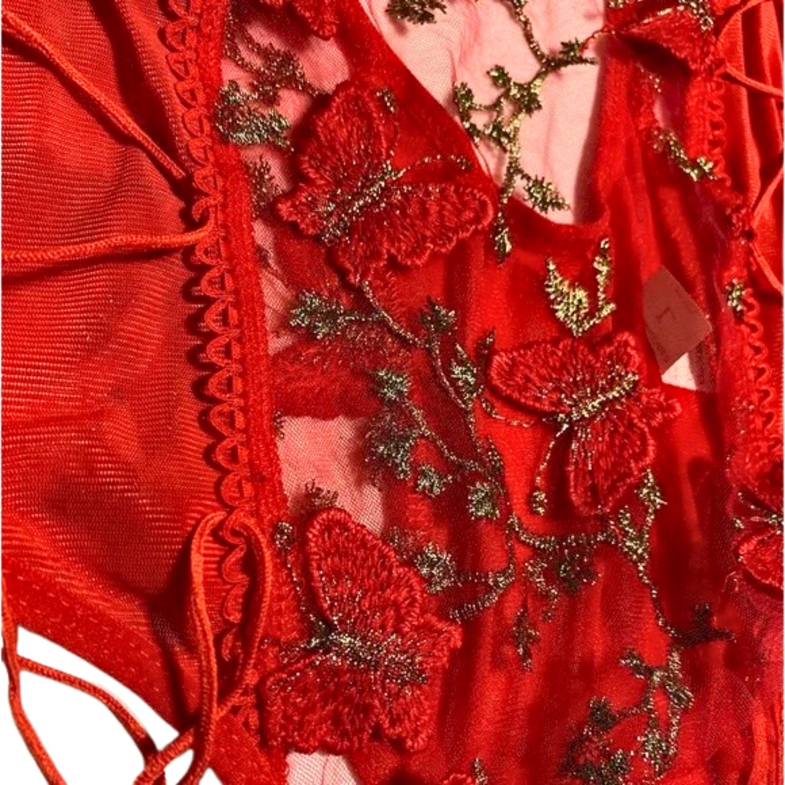Red garment with gold embroidery and lace details