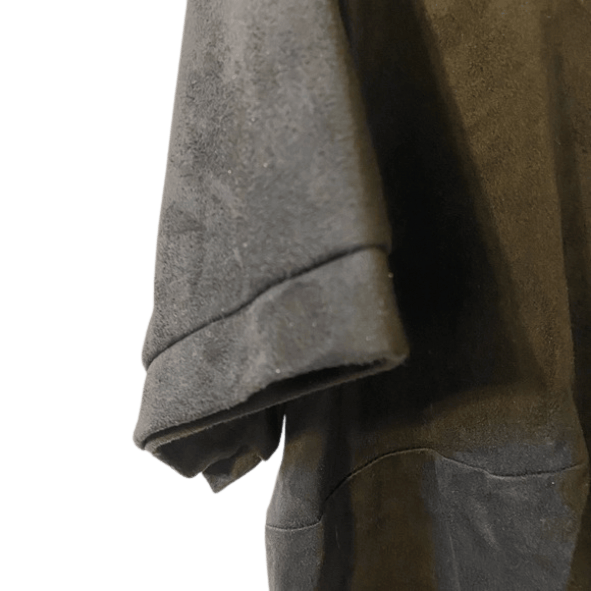 Close-up of a textured gray garment with a green background