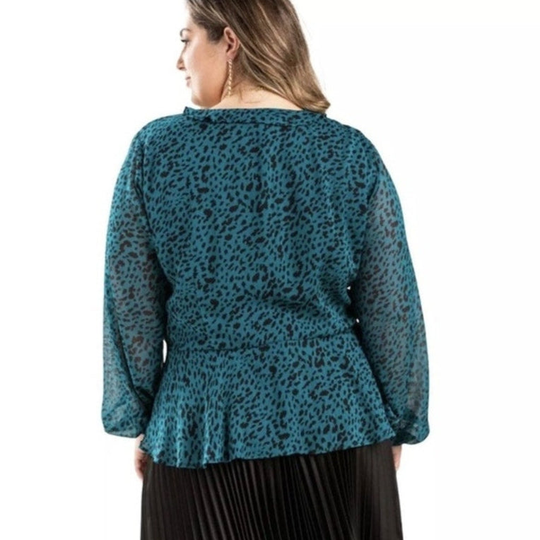 Woman wearing a blue leopard print blouse on a white background