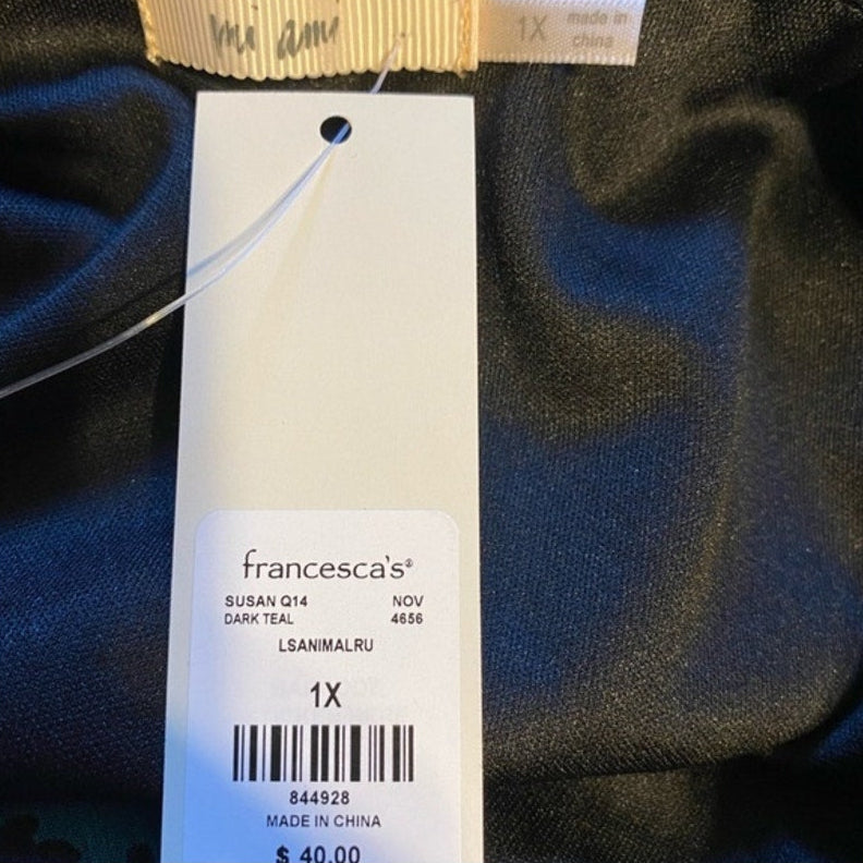Clothing tag with 'francesca's' brand name on a dark fabric background