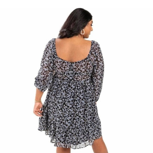 Woman wearing a black floral dress on a white background
