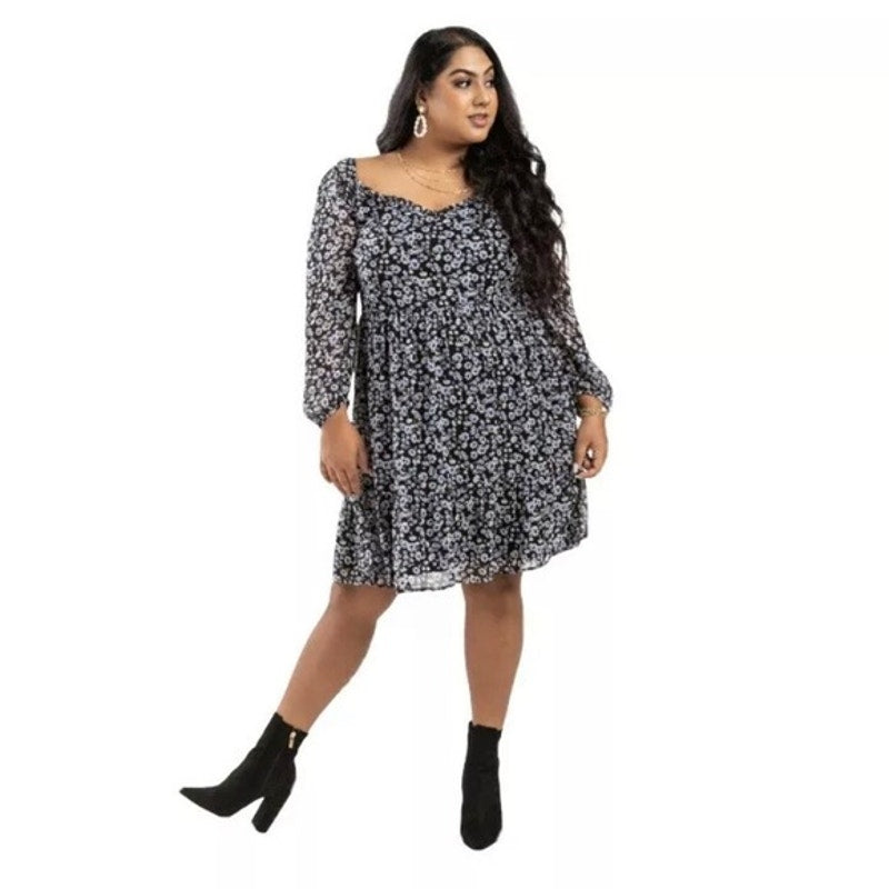 Woman wearing a black floral dress on a white background